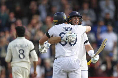 Joe Root and Jamie Smith celebrate England's victory over India.
